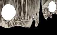 Urahara leads Hiyori down a set of stairs in a subterranean cave.