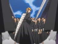 Ichigo is surrounded by dozens of Shinigami.