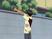Sado places Yūichi on a wall to keep him safe.