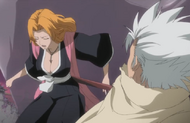 Rangiku pushes a large stone off of Hitsugaya.