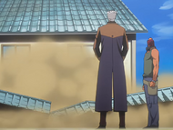 Koga watches as Kariya destroys a wall and house.