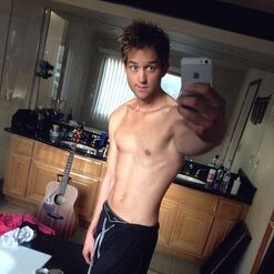 Bill taking a selfie of himself shirtless.