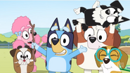 The ringmaster, clown, acrobat, lion tamer, muscleman and lion putting on a show for the audience