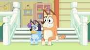 Chilli and Bluey sit down on the steps to watch.
