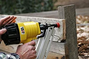 Pneumatic nail gun in use.