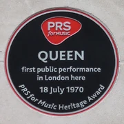 A plaque noting the first public performance by .