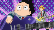 Mineta trying to play the guitar