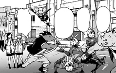 The thugs are unable to hit a carefree Koichi.