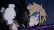 Denki grabs Izuku to prevent him from running away.