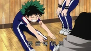Izuku does seated toe-touch.