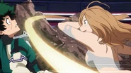 Camie scratches Izuku's face.