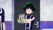 Izuku holding his hero notebook