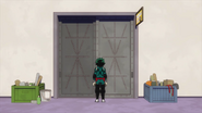 Izuku stands outside the Development Studio