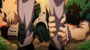 Izuku and Katsuki grab Nine's legs.