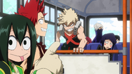 Mezo sitting on the bus while Tsuyu teases Katsuki.