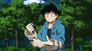 Izuku wearing the support gloves.