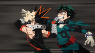 Katsuki throws Izuku toward the escape gate.