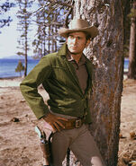 Michael-landon-leaning-up-against-a-tree-in-bonanza-picture-