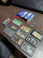 Photo of multiple GBA cartridges from the same auction listing, with the Russian release of Teenage Mutant Ninja Turtles II circled in red.
