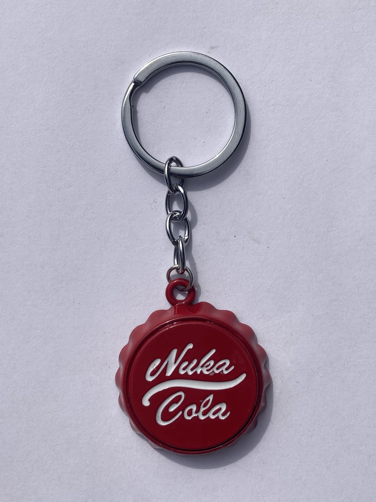 Nuka Cola small bottle cap shaped red colored metal bottle opener