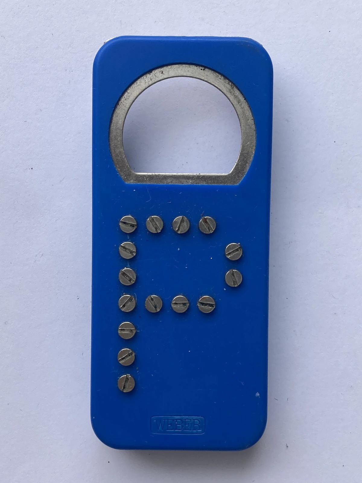 Rectangleshaped blue plastic bottle opener with uppercase letter 'P