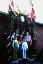 "Golden wedding anniversary, our grandparents and six grandchildren at the front door where neighbors had set up a port of honor."