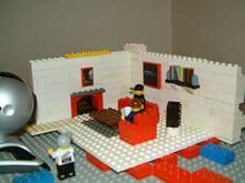 "The modular walls in action! I built the living room set as three separate walls which were held in place by the baseplate and a brick at the top to hold them together at the corners."