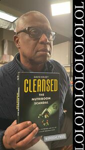 Posing with a Nutriboom book prop he and Stephanie Beatriz found while filming on set