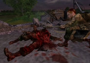Hartsock staring at Desola's mutilated corpse, feeling sad for the loss of another friend.