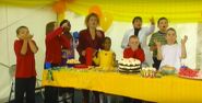 The children watch as the cake falls