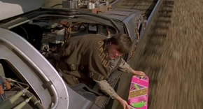 Marty holding the hoverboard above the tracks of the Spur.