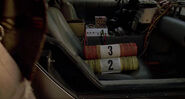 The yellow and red Presto logs, labeled 2 and 3 respectively, on the passenger seat of the DeLorean.