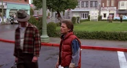 A man in a hat & plaid jacket is the first to notice's Marty attire, while crossing the street.