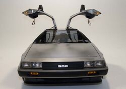 De Lorean DMC-12 with gull-wing doors open.