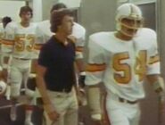 Larry Ball (No. 53), a Bucs player, John McKay (no uniform), and Steve Colavito (No. 54) in the locker room, right before their first game in franchise history against the Los Angeles Rams.