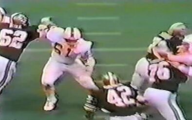 Dewey Selmon (No. 61) sheds the block of John Hill (No. 62), with Chuck Muncie (No. 42) ready to block, Don Morrison (No. 76) and Emmanuel Zanders (No. 79) blocking.