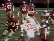 Mark Cotney (No. 33) zeroes in on Don Woods (No. 47), while Ron Singleton (No. 67), John Ayers (No. 68), Keith Farnhorst (No. 71), Dave Pear (No. 76), and Randy Cross (No. 51).