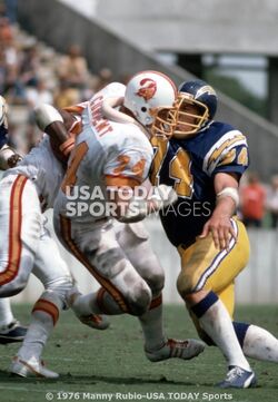 Mike Current (No. 74) blocks Louis Kelcher (No. 74) while Charlie Davis (With the football).