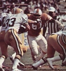 Dewey Selmon (No. 61) sheds a block in order to tackle Barty Smith (No. 33) in a 1978 game against the Green Bay Packers.