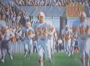 Larry Ball (No. 53), Pat Toomay (No. 66), Glenn Robinson (No. 64), and another Buccaneers player on the field at an unknown game and unknown date.