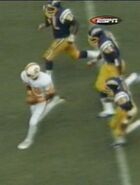 Dickinson runs the ball with three San Diego Chargers on pursuit.