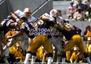 Lee Roy Selmon (No. 63) and his brother Dewey (No. 61) are doubled by the San Diego Chargers' Charles Aui (No. 62), Russ Washington (No. 70), and Pat Curran (No. 82).