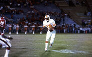 Parnell Dickinson runs with the ball against the Atlanta Falcons, in their lone win of the 1976 season. Atlanta Falcons cornerback Frank Reed is on pursuit.