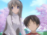 Tomoyo walking with Takafumi beneath the cherry blossoms in Counter Measures.