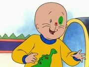 Caillou now must wear a sweater that Grandma gave him, which happens to have a dinosaur on it.