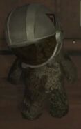 A teddy bear wearing a helmet in Moon.
