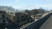 At the market, east of the freeway, multiple storage garages, stores such as an air conditioner shop, barber shop and a Burger Town, and finally multiple housing and apartments. Nearby a Comms Tower can be found.