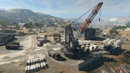A massive marble yard sits here next to a crane, trucks and a warehouse. In this warehouse, a locker room, interior bay and office can be found inside.