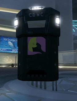 A planted Assault Shield bearing custom emblem and clan tag. Emblem and tag are also on the handle, visible to the user. Note the embedded front lights that are always on, but more visible in a dark environment.