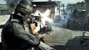 An OpFor soldier opening fire with an M249 SAW.